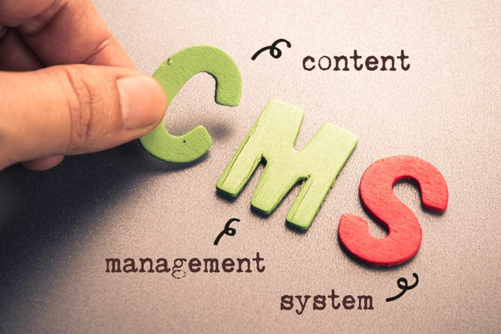 Hand arrange wood letters as CMS (Content Management System)